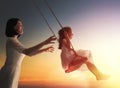 Mother and daughter swinging on swings Royalty Free Stock Photo