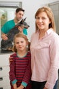 Mother And Daughter Taking Dog For Examination At Vets