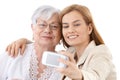 Mother and daughter taking photo of themselves Royalty Free Stock Photo