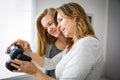 Mother and daughter taking photos and checking them Royalty Free Stock Photo