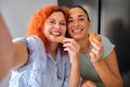 Mother and daughter taking a selfie while eating homemade butter cookies. Royalty Free Stock Photo