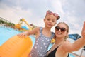 Mother and daughter taking selfie near pool in water park Royalty Free Stock Photo