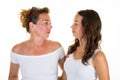 Mother and daughter teen are hugging looking each other smiling isolated over white background Family Love