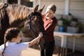 Mother and daughter touching the horse