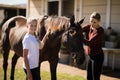 Mother and daughter touching the horse