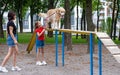 Mother with daughter training golden retriever dog Royalty Free Stock Photo