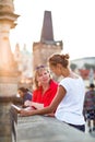 Mother and daughter traveling - two tourists studying a map