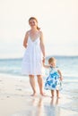 Mother and daughter on tropical beach at sunset Royalty Free Stock Photo