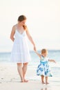 Mother and daughter on tropical beach at sunset Royalty Free Stock Photo