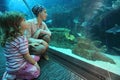 Mother and daughter in underwater aquarium tunn Royalty Free Stock Photo