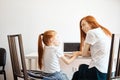 Mother and daughter using laptop computer at home Royalty Free Stock Photo