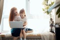 Mother and daughter using laptop computer at home Royalty Free Stock Photo