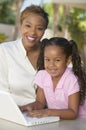 Mother and Daughter Using Laptop on patio portrait Royalty Free Stock Photo