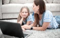 Mother and daughter using a laptop in their home Royalty Free Stock Photo