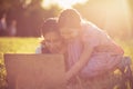 Mother daughter using laptop together in nature Royalty Free Stock Photo