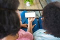 Mother and daughter using mobile phone while sitting at home, copy space