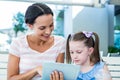 Mother and daughter using tablet computer together Royalty Free Stock Photo