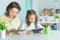 Mother and daughter using tablets