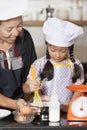 Mother and daughter using whisk to mix egg and wheat flour Royalty Free Stock Photo