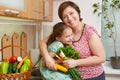 Mother and daughter with vegetables and fresh fruits in kitchen interior. Parent and child. Healthy food concept Royalty Free Stock Photo