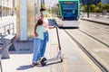 Mother and daughter waiting for the train with an electronic scooter. Royalty Free Stock Photo