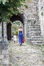 Mother and daughter walk among the ruins of the old town in Budv