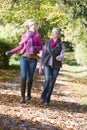 Mother and daughter on walk through woods