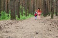 Mother and daughter walking along the forest Royalty Free Stock Photo