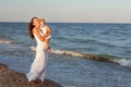 Mother and daughter are walking along the seashore Royalty Free Stock Photo