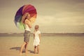 Mother and daughter walking on the beach