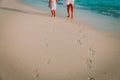 Mother and daughter walking on beach leaving footprint in sand Royalty Free Stock Photo