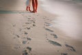 Mother and daughter walking on beach leaving footprint in sand Royalty Free Stock Photo