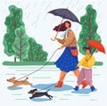Mother and daughter are walking the dogs during the rainy weather. Happy family day in the rain Royalty Free Stock Photo