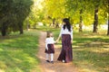 Mother and daughter walking in the Park and enjoying the beautifu nature