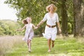Mother and daughter walking on path holding hands Royalty Free Stock Photo