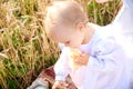 Mother and daughter in wheat field. Happy Family outdoors. healthy child with mother on picnic with bread and milk in golden