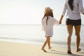 Mother and daughter who enjoy a picnic and sea bathing at the beach on sunset in holiday. Royalty Free Stock Photo