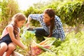 Mother And Daughter Working On Allotment Together Royalty Free Stock Photo