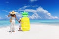 A mother and daughter with a yellow floatie on summer holidays Royalty Free Stock Photo