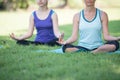 Mother and daughter with yoga exercise outdoors at the park. Health and Fitness concept Royalty Free Stock Photo