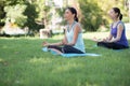 Mother and daughter with yoga exercise outdoors at the park. Health and Fitness concept Royalty Free Stock Photo