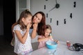 Mother and daughters baking together in kitchen with joy Royalty Free Stock Photo