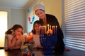 Mother and daughters kindling candles on the eight day of Hanukkah Jewish holiday festival