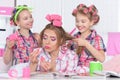 Mother and daughters making hairstyles