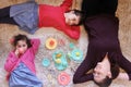 Mother and daughters playing together having a tea party