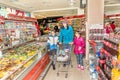 Mother and daughters shopping in grocery store