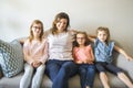 Mother and daughters on sofa at home