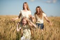 Mother and daugthers run on wheat filed Royalty Free Stock Photo