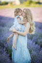 Mother and dauther in lavender field in blu dress Royalty Free Stock Photo