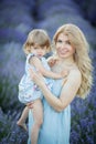 Mother and dauther in lavender field in blu dress Royalty Free Stock Photo